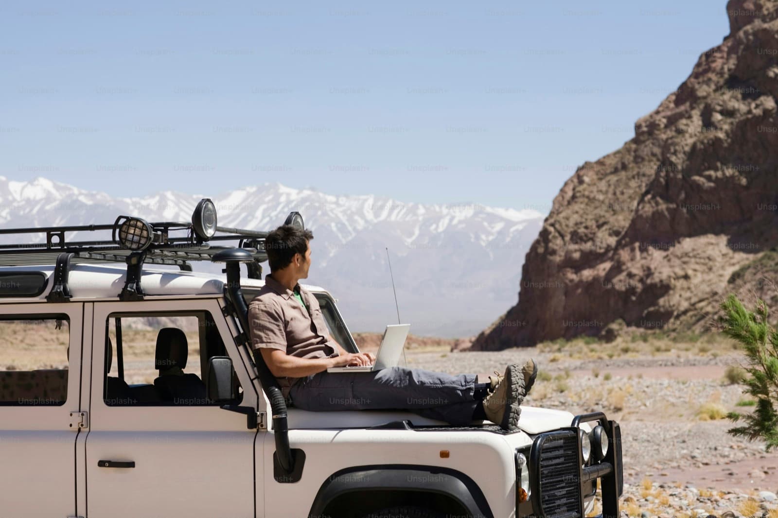 A man sitting on top of a white truck